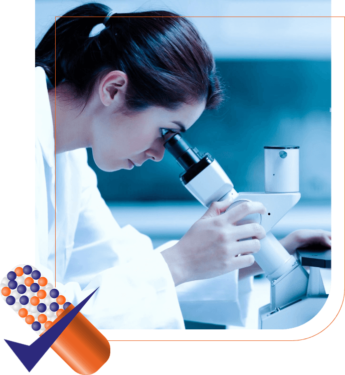 A woman looking through a microscope in a lab.