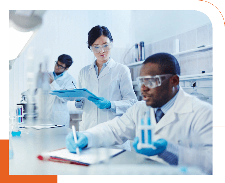 A group of people in lab coats and goggles.